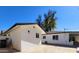 Back exterior of home with connected garages and desert landscaping at 8002 N 5Th Ave, Phoenix, AZ 85021