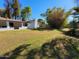 Lush backyard featuring a white house, chimney, and mature trees at 8002 N 5Th Ave, Phoenix, AZ 85021