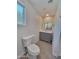 Bathroom featuring a toilet, a sink with gray cabinets, a mirror, and hexagon tile flooring at 8002 N 5Th Ave, Phoenix, AZ 85021