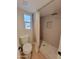 Bathroom with a tiled shower, mosaic floor, a modern toilet, and a window for natural light at 8002 N 5Th Ave, Phoenix, AZ 85021