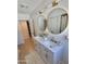Bright bathroom featuring a double sink vanity with marble countertop and elegant gold fixtures at 8002 N 5Th Ave, Phoenix, AZ 85021