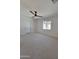 Clean and bright bedroom with neutral carpet, a ceiling fan, and natural light from a window at 8002 N 5Th Ave, Phoenix, AZ 85021