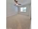 Spacious bedroom with neutral carpet, ceiling fan, and a window that provides ample natural light at 8002 N 5Th Ave, Phoenix, AZ 85021