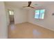 Bright bedroom with wood look tile flooring, modern ceiling fan, and neutral colors at 8002 N 5Th Ave, Phoenix, AZ 85021