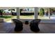 A view of the covered patio with stylish seating, overlooking the lush backyard offering a serene outdoor experience at 8002 N 5Th Ave, Phoenix, AZ 85021