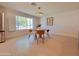 Bright dining room with large window, modern light fixture and tiled floors at 8002 N 5Th Ave, Phoenix, AZ 85021