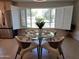 Bright dining room with large window, modern light fixture and tiled floors at 8002 N 5Th Ave, Phoenix, AZ 85021