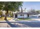 Charming home featuring an inviting front yard with mature trees and a covered parking area at 8002 N 5Th Ave, Phoenix, AZ 85021