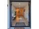 Open foyer with wood look floors, chandelier, bench, and natural light at 8002 N 5Th Ave, Phoenix, AZ 85021