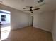Bright living room featuring tile flooring, a modern ceiling fan, and ample natural light at 8002 N 5Th Ave, Phoenix, AZ 85021
