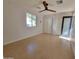 Bright room featuring wood-look tile floors, ceiling fan, access to closet, and windows at 8002 N 5Th Ave, Phoenix, AZ 85021