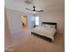 Spacious main bedroom featuring a ceiling fan, king bed and an ensuite bathroom at 8002 N 5Th Ave, Phoenix, AZ 85021