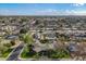 Expansive aerial view showcasing a neighborhood with mature trees, and a unique home design with circular driveway at 801 W Tyson St, Chandler, AZ 85225