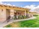 Beautiful back porch with a covered area, brick accents, and lush landscaping that blends the indoors and outdoors at 801 W Tyson St, Chandler, AZ 85225