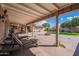 This backyard with lush lawn has a covered patio area, a built in firepit, and a seating area at 801 W Tyson St, Chandler, AZ 85225