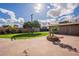 Expansive backyard featuring green lawn, mature tree, and charming fountain in a well-maintained landscape at 801 W Tyson St, Chandler, AZ 85225