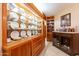 Wet bar with a wine refrigerator and built-in glass display cabinets, perfect for entertaining at 801 W Tyson St, Chandler, AZ 85225