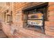 Brick outdoor fireplace with built-in grilling station for cozy outdoor cooking and entertaining at 801 W Tyson St, Chandler, AZ 85225