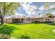 Beautiful single-story home with a spacious, manicured front lawn and charming architectural details at 801 W Tyson St, Chandler, AZ 85225