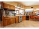 Vintage kitchen featuring stainless steel appliances, tiled floors and countertops, and wood cabinetry at 801 W Tyson St, Chandler, AZ 85225