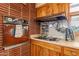 Close-up of kitchen with retro oven, cooktop, spice rack and wood cabinets at 801 W Tyson St, Chandler, AZ 85225