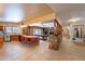 Open-concept kitchen with tile floors, bar seating, and adjacent billiards room and hallway at 801 W Tyson St, Chandler, AZ 85225