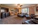 Cozy living room with leather furniture, ceiling fan, and large windows at 801 W Tyson St, Chandler, AZ 85225