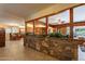 Open-concept living area with wood paneling, decorative stone wall, and tile flooring at 801 W Tyson St, Chandler, AZ 85225