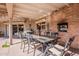 Outdoor dining on the patio, has seating for six people and built in brick fireplace and grill at 801 W Tyson St, Chandler, AZ 85225