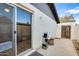 Small fenced backyard with patio and access to the home through a glass sliding door at 828 W Laguna Dr, Tempe, AZ 85282