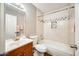A bathroom with a single vanity, tiled shower, and built-in storage niche at 828 W Laguna Dr, Tempe, AZ 85282