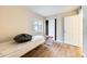 A bare bedroom featuring a queen mattress, wood flooring, and a sliding closet at 828 W Laguna Dr, Tempe, AZ 85282