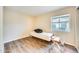 Bedroom with bare mattress, wood flooring, and natural light streaming through window at 828 W Laguna Dr, Tempe, AZ 85282