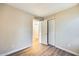 A vacant bedroom featuring a neutral wall color, wood floors, and a large closet at 828 W Laguna Dr, Tempe, AZ 85282