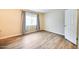 Bright bedroom with wood floors and a window dressed in patterned curtains at 828 W Laguna Dr, Tempe, AZ 85282