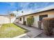 Side view of a single-story home with manicured landscaping, a well-kept lawn, and a tidy walkway at 828 W Laguna Dr, Tempe, AZ 85282