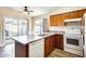 Well-lit kitchen featuring wood cabinets, matching appliances, and a slider leading to the backyard at 828 W Laguna Dr, Tempe, AZ 85282
