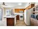 A classic-style kitchen is equipped with wood cabinetry and white appliances at 828 W Laguna Dr, Tempe, AZ 85282