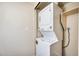Stackable washer and dryer setup with a wood shelf installed above the units at 828 W Laguna Dr, Tempe, AZ 85282