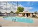View of the outdoor community swimming pool with chairs at 828 W Laguna Dr, Tempe, AZ 85282