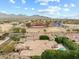 Wide aerial view displaying the home's location, roof, and proximity to nearby schools and mountains at 9869 E Davenport Dr, Scottsdale, AZ 85260