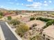 Expansive aerial shot showcasing the home's landscaping, neighborhood, and community amenities at 9869 E Davenport Dr, Scottsdale, AZ 85260