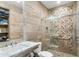 Bathroom featuring a sink, toilet, shower with custom tile work, and decorative accents at 9869 E Davenport Dr, Scottsdale, AZ 85260