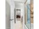 Bathroom with tiled shower and glass door leading to a bedroom with desk and adjacent vanity at 9869 E Davenport Dr, Scottsdale, AZ 85260