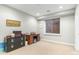 Bedroom area with a window, small desk, dresser, and carpeted flooring at 9869 E Davenport Dr, Scottsdale, AZ 85260