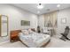 Bedroom with a wood bed frame, carpet floor, and a glass desk by a window at 9869 E Davenport Dr, Scottsdale, AZ 85260