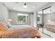 Bright bedroom featuring a decorative metal bed frame, ensuite, and a sliding mirror door closet at 9869 E Davenport Dr, Scottsdale, AZ 85260