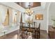 Bright dining area boasts designer chandelier, tray ceiling, and large windows at 9869 E Davenport Dr, Scottsdale, AZ 85260