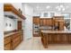 Gourmet kitchen with custom wood cabinets, granite counters, and stainless appliances at 9869 E Davenport Dr, Scottsdale, AZ 85260
