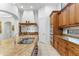 Gourmet kitchen featuring granite island, stainless steel faucet, and custom cabinetry at 9869 E Davenport Dr, Scottsdale, AZ 85260